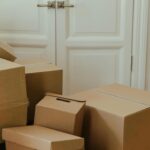 Cardboard boxes stacked in an apartment, signifying a move-in or relocation process.